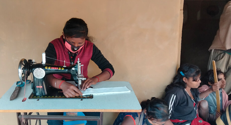 A girl stitching sanitary pads in Karhariya, Jharkhand